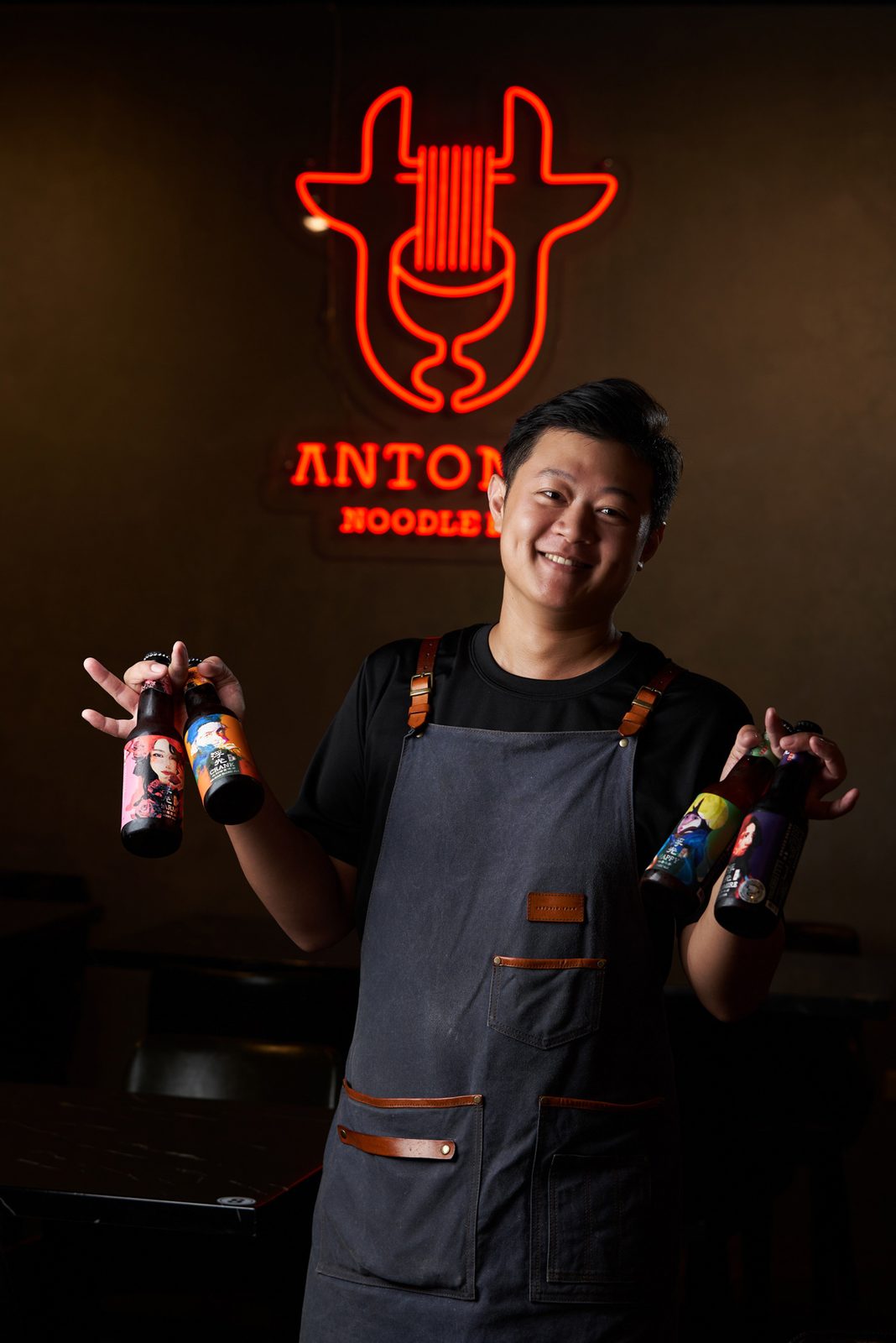 Anthony 站在安東牛麵吧的霓虹標誌下